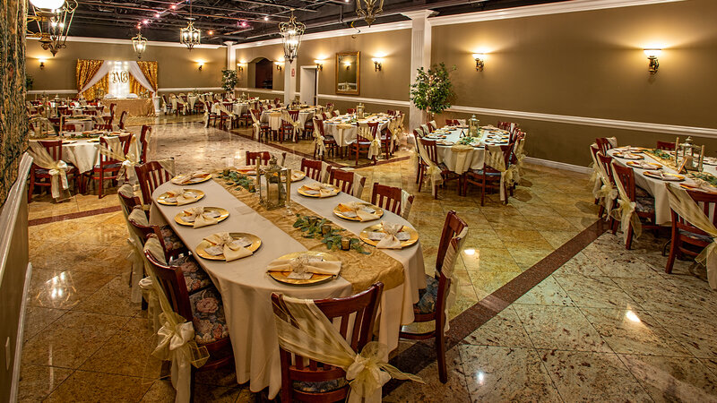 Long tables with white and gold table settings