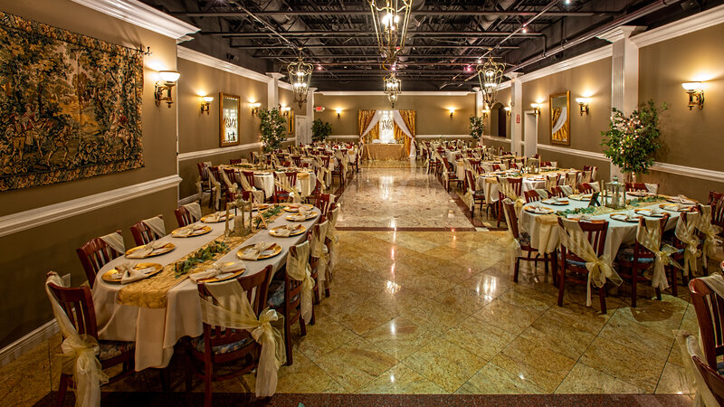 View of entire private dining room with many set tables with gold and white decor