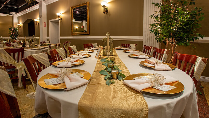 Gold and white table setting at long table